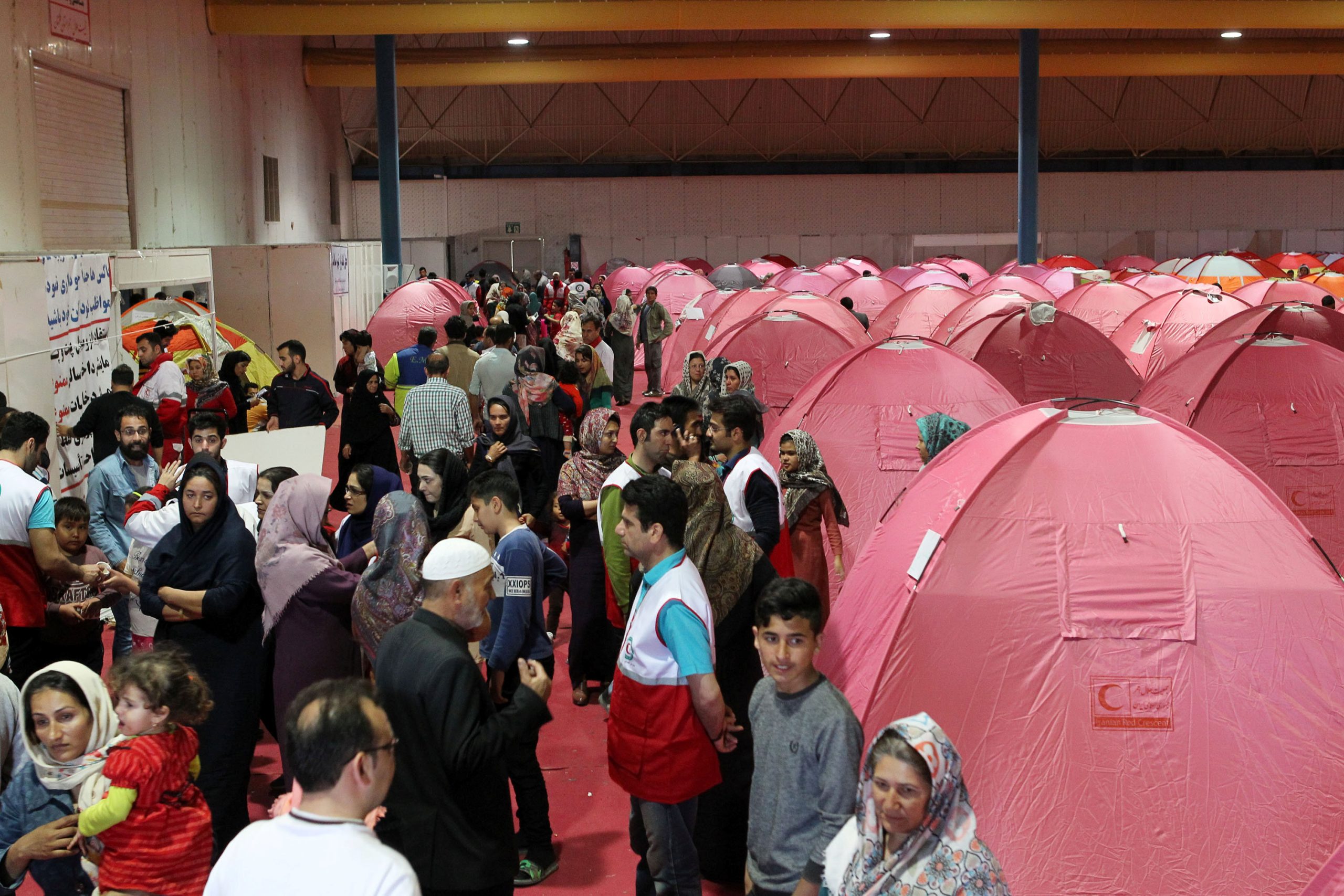 People are seen sheltering at a stadium after a flooding in Golestan province